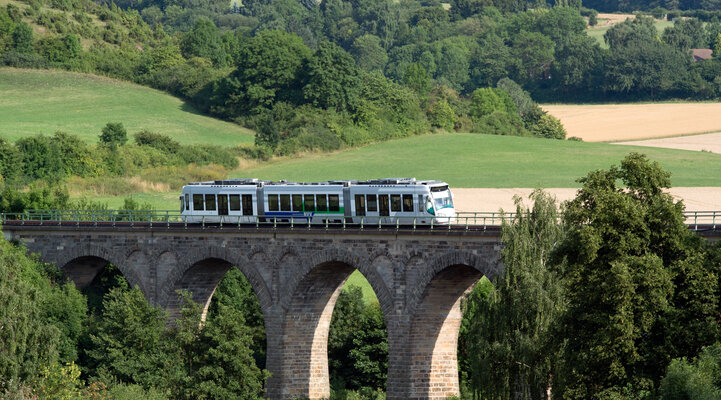 Eine Tram fährt über eine Brücke